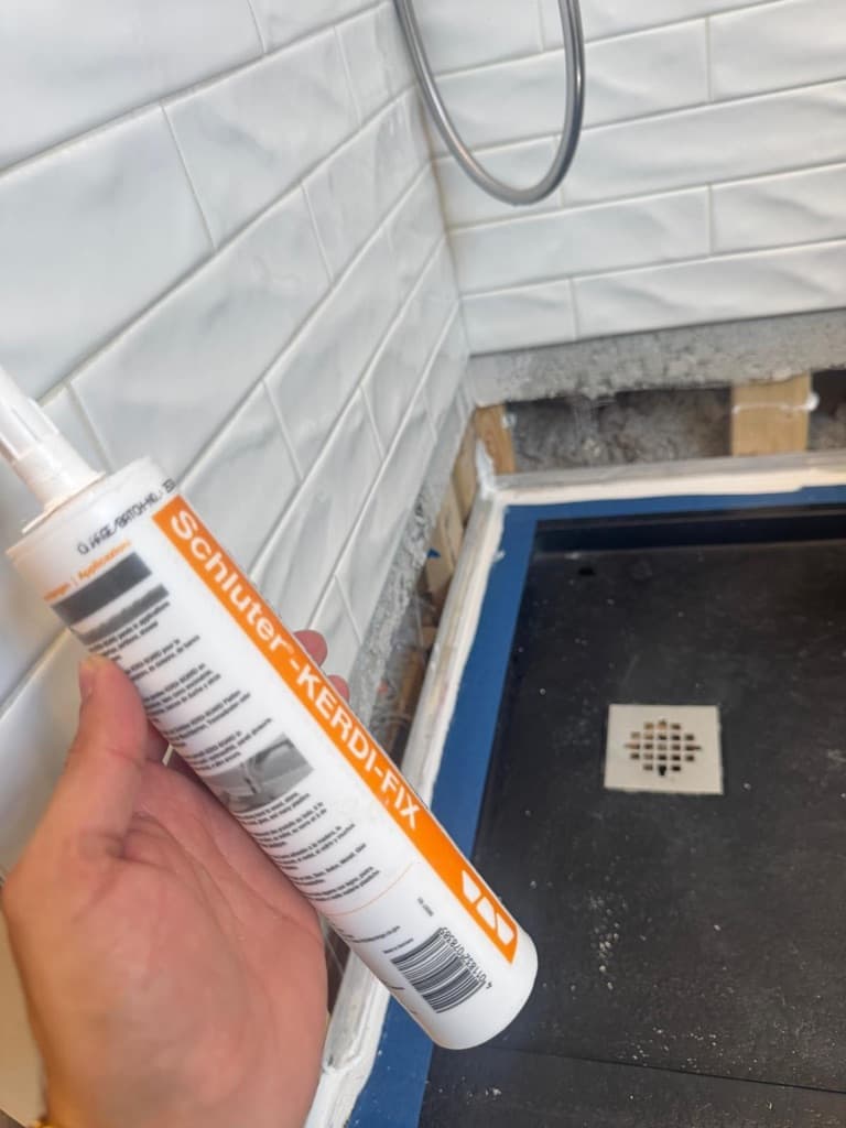 System-compatible sealant used at critical shower transitions